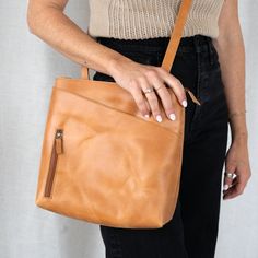 Our Sojourner Backpack was designed with an on-the-go lifestyle in mind. This 2-in-1 crossbody and backpack holds all your essentials and features adjustable straps. You'll love this bag for its hands-free versatility and unique style. * 10" wide, 10.5" tall, 2.5" deep * 2-in-1 crossbody and backpack * Phone pocket outside for easy access * Fully-lined inside * 2 open pockets and 1 zipper pocket inside * 1 large open pocket with button closure outside * 1 zipper pocket outside * Adjustable strap Modern Bags With Detachable Strap For Everyday, Modern Everyday Bag With Detachable Strap, Leather Shoulder Bag With Detachable Strap For Everyday, Leather Crossbody Backpack For Everyday, Everyday Carry Backpack Shoulder Bag, Everyday Carry Shoulder Bag Backpack, Everyday Carry Shoulder Backpack, Modern Leather Crossbody Backpack With Leather Lining, Backpack With Leather Lining For Everyday Use