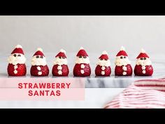 strawberry santas are lined up on a table with the words strawberries in front of them