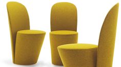 three yellow chairs sitting next to each other