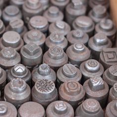 an assortment of metal typewriters sitting on top of each other