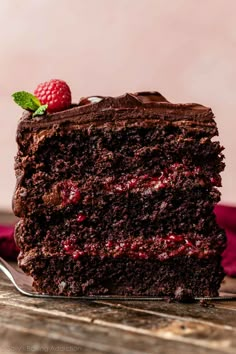 a slice of chocolate cake with raspberries on top