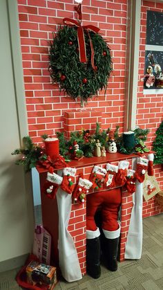 a brick fireplace decorated for christmas with stockings and decorations