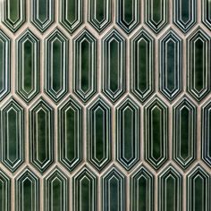 an abstract pattern made up of green and white tiles