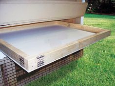 an open storage box sitting on top of some grass