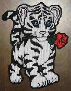 a white tiger with a red rose in its mouth