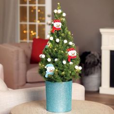 a small christmas tree sitting on top of a wooden table