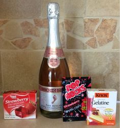 a bottle of wine and some snacks on a counter