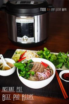 an instant pot beef pho recipe with chopsticks and vegetables on the side