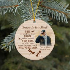 a wooden ornament with an image of a man holding a hat on it