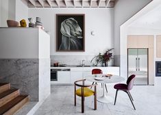 an open kitchen and dining area with marble floors