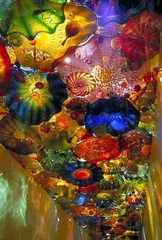 the ceiling is made up of many colorful glass objects