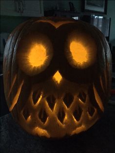 a carved pumpkin with glowing eyes on it