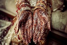 a woman's hands covered in hennap