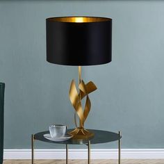 a table with a lamp on it next to a chair