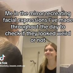 a woman is looking at her reflection in the mirror