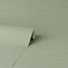 a roll of light green colored paper on top of a table