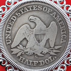 an old silver coin with the seal of the united states of america in it's center