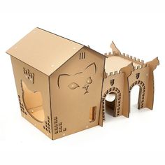 a cardboard house with a cat face cut out of it's front and side