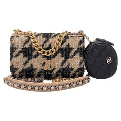 Store item: 67757 The WOC is a must-have Chanel due to its chic style and extreme versatility. The long 24-inch woven silver chain can be worn single across the body, double on the shoulder, triple as a hand purse or inside the bag, as a clutch. Detailed and ornate while just as functional, this very rare wallet on chain is designed with intricate fibers of tweed that is so very quintessential Coco Chanel. From the Chanel 19 collection, the recent ligne released by Chanel that became popular overnight for its woven chain "CC" logo, thick chunky woven chain in four different hardwares and the extra chain handle. The tweed Chanel 19 wallet on chains uniquely come with a detachable quilted round lambskin coin purse. Interior button is a magnetic button, allowing for easier one-hand closure. I Chanel 19 Wallet On Chain, Leather Blouse, Structured Shoulder, Chanel 19, Metal Cuff Bracelet, Chanel Inspired, Hounds Tooth, Woven Chain, Black Houndstooth