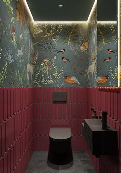 the bathroom is decorated with colorful wallpapers and animal themed tiles, along with a toilet