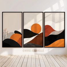 three framed art prints on the wall in an empty room with wood flooring and white walls