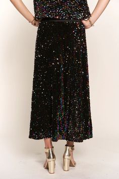 This Sequin Maxi Skirt is perfect for holidays and special occasions. The elastic waistband makes it comfortable and easy to wear, and the fully sequin design adds a touch of glamour. Whether it's a party or celebrating your favorite holiday, this maxi skirt adds the perfect finishing touch to any look. Fit: The skirt is intended to be fitted at the waist and relaxed throughout the hips and legs. Waist: The waist is intended to be fitted and ranges from 27" to 31" Hips: The hips are intended to Glamorous Floor-length Skirt For Night Out, Party Maxi Skirt With Lining, Disco Style Skirt For Evening Party Season, Disco Style Evening Skirt For Party Season, Disco Style Skirt For Evening And Party Season, Long Skirt For Prom And Party Season, Floor-length Party Bottoms For Spring, Evening Glitter Skirt For Party Season, Glamorous Maxi Skirt For Party Season