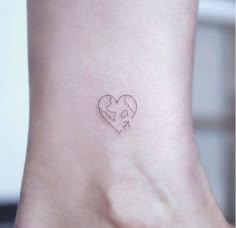 a small heart tattoo on the ankle