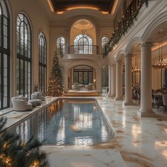 a large indoor swimming pool surrounded by columns