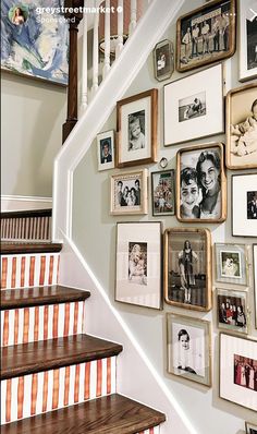 a staircase with many framed photos on the wall