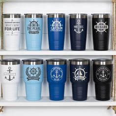 several different colored tumblers are lined up on the shelf