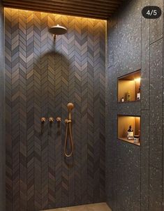 a bathroom with a walk in shower and tiled walls