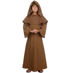 a young boy dressed in a monk costume with his hands folded out to the side