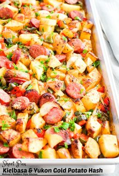 a casserole dish with sausage, potatoes and herbs