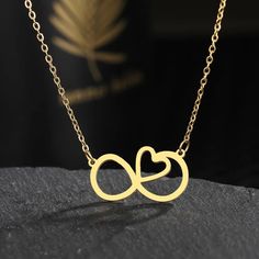 Stainless Steel Infinity Symbol Heart Pendant Necklace This stunning necklace features an infinity symbol intertwined with a heart pendant, exuding timeless elegance and symbolizing eternal love. Crafted from high-quality stainless steel, this necklace is a perfect accessory for any occasion. Metal Type: Stainless Steel Shape/Pattern: Heart Necklace Length: 45cm Experience the enduring beauty and durability of stainless steel with this exquisite necklace. Its resistance to fading, tarnishing, an Stainless Steel Double Heart Necklace For Anniversary, Stainless Steel Double Heart Jewelry With Adjustable Chain, Elegant Stainless Steel Heart Necklace For Mother's Day, Elegant Double Heart Stainless Steel Necklace, Valentine's Day Rose Gold Infinity Necklace, Heart Charm Infinity Necklace For Valentine's Day, Infinity Heart Charm Necklace For Valentine's Day, Stainless Steel Heart Pendant Necklace For Anniversary, Infinity Clavicle Chain Necklace As Gift