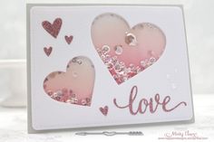 a close up of a card with two hearts on it and the word love written in pink