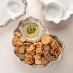 an assortment of crackers and dip in a bowl