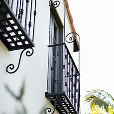 a balcony with wrought iron railing and balconies on the side of a building