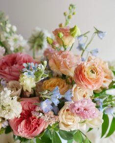 a vase filled with lots of different colored flowers