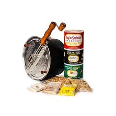 an assortment of spices and tins on a white background with a fishing reel in the foreground