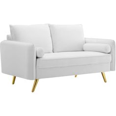 a white couch with gold legs and pillows