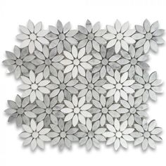 a white and grey flower pattern on a wall with the words vulcanno written in black