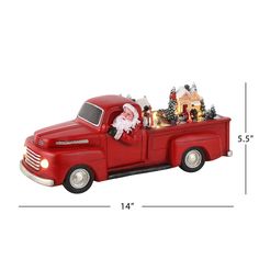 an old fashioned red truck with christmas decorations in the bed and santa clause on it's back