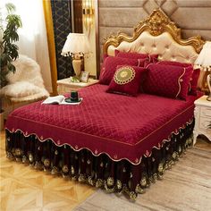 a bed with red bedspread and gold trimmings