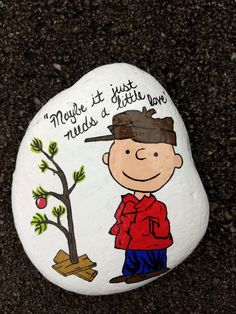 a painted rock with a boy and a tree on it that says, nature is just needs a little love