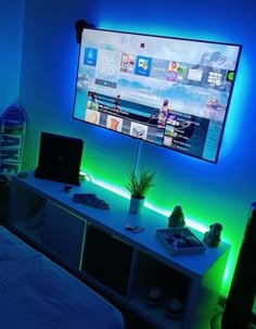 a flat screen tv mounted on the wall above a bed in a room with blue lighting