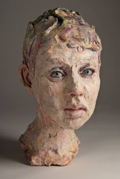 a close up of a sculpture of a person with hair on it's head