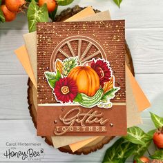 a close up of a card on a table with leaves and flowers in the background