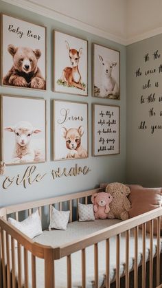 a baby's room with pictures on the wall and a crib next to it