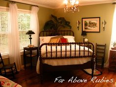 a bed room with a neatly made bed and a chandelier