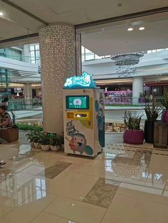 an atm machine sitting in the middle of a shopping mall